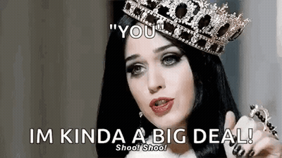 A Woman Wearing A Crown Is Pointing At The Camera And Saying `` You '' . GIF