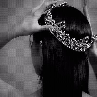 A Woman Wearing A Crown On Her Head In A Black And White Photo GIF