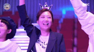A Woman Wearing A Crown On Her Head Is Smiling GIF
