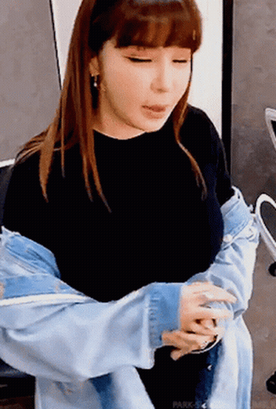 A Woman Wearing A Denim Jacket And A Black Shirt GIF