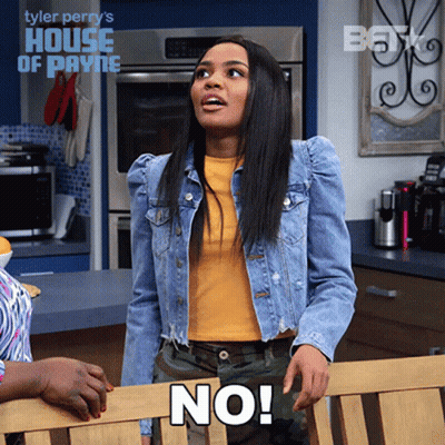 A Woman Wearing A Denim Jacket And A Yellow Shirt Says " No " GIF