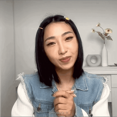 A Woman Wearing A Denim Jacket Has The Number 21 On The Bottom Of Her Picture GIF