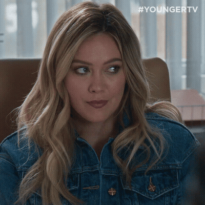 A Woman Wearing A Denim Jacket Has #Youngertv Written On The Bottom GIF
