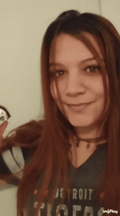 A Woman Wearing A Detroit Tigers T-Shirt Smiles For The Camera GIF