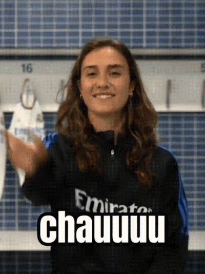 A Woman Wearing A Emirates Shirt Is Smiling And Giving A High Five GIF