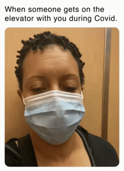 A Woman Wearing A Face Mask In An Elevator GIF