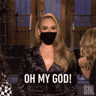 A Woman Wearing A Face Mask Is Standing In Front Of A Group Of People . GIF