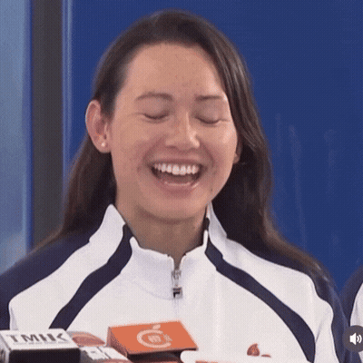 A Woman Wearing A Fila Jacket Is Laughing GIF