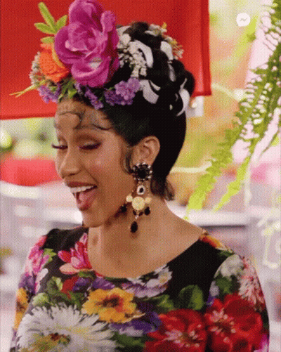 A Woman Wearing A Floral Shirt And A Flower Crown On Her Head GIF