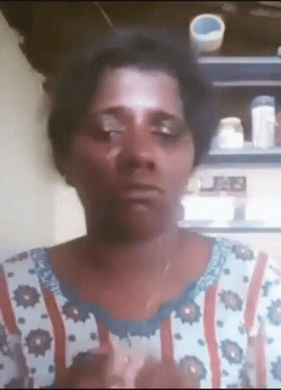 A Woman Wearing A Floral Shirt Is Making A Funny Face With Her Eyes Closed GIF