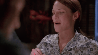 A Woman Wearing A Floral Shirt With Her Mouth Open GIF