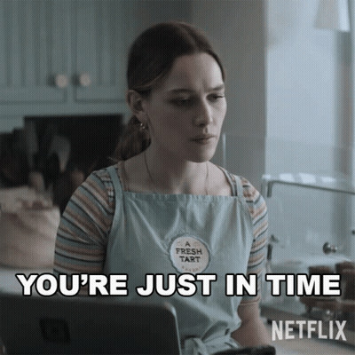 A Woman Wearing A Fresh Tart Apron Is Sitting In Front Of A Laptop And Says You 'Re Just In Time GIF