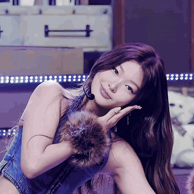 A Woman Wearing A Fur Cuff And A Denim Vest GIF