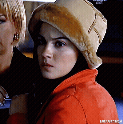 A Woman Wearing A Fur Hat And A Red Jacket With The Words Edits Portirroni On The Bottom GIF