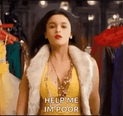 A Woman Wearing A Fur Vest And A Yellow Top Is Standing In Front Of A Clothes Rack And Asking For Help . GIF