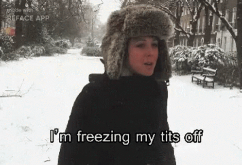 A Woman Wearing A Furry Hat Is Standing In The Snow And Says `` I 'M Freezing My Tits Off '' . GIF