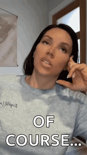 A Woman Wearing A Gray Shirt Says Of Course GIF