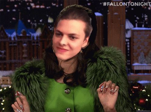 A Woman Wearing A Green Fur Coat And Red Nails Has #Fallontonight Written On The Bottom GIF