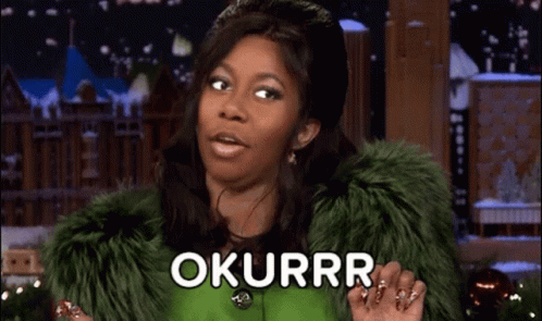 A Woman Wearing A Green Fur Coat Is Holding Her Hands Together And Saying Okurrr . GIF