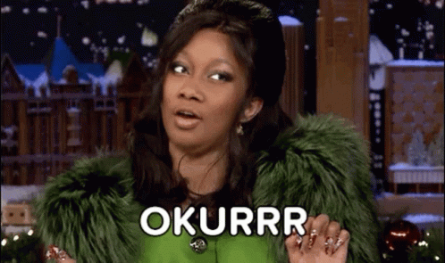 A Woman Wearing A Green Fur Coat Is Making A Funny Face And Saying Okurrr . GIF