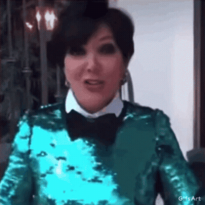 A Woman Wearing A Green Sequined Top And A Black Bow Tie Is Making A Funny Face . GIF