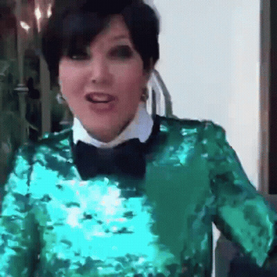 A Woman Wearing A Green Sequined Top And A Bow Tie GIF