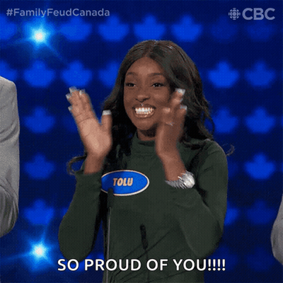 A Woman Wearing A Green Sweater With The Name Tolu On It Applauds GIF