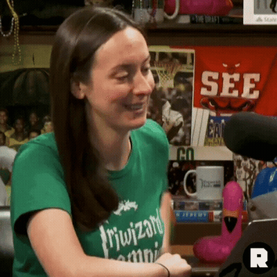 A Woman Wearing A Green T-Shirt That Says " Riwizard " On It GIF