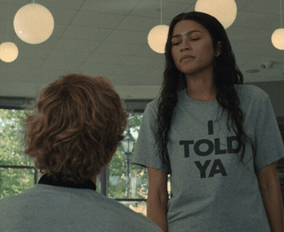 A Woman Wearing A Grey T-Shirt That Says I Told Ya GIF