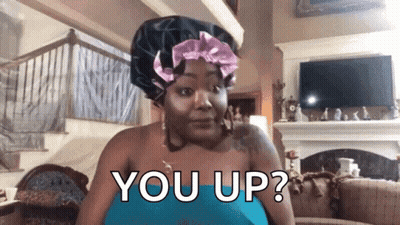 A Woman Wearing A Hair Bonnet Is Sitting In A Living Room And Asking You Up ? GIF