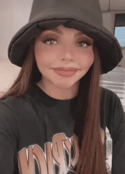 A Woman Wearing A Hat And A Black Shirt That Says Disco GIF
