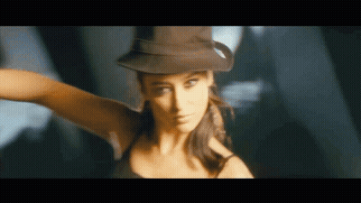 A Woman Wearing A Hat And A Black Tank Top Is Dancing GIF