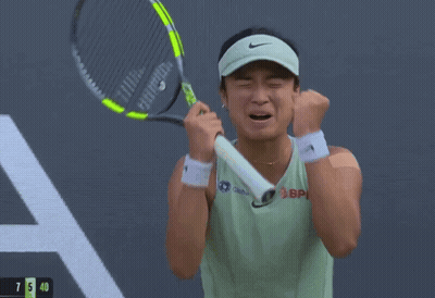 A Woman Wearing A Hat And A Green Tank Top With The Word Asics On It GIF