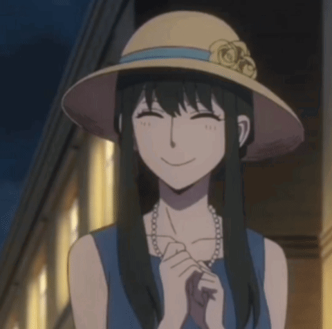 A Woman Wearing A Hat And A Pearl Necklace Smiles For The Camera GIF