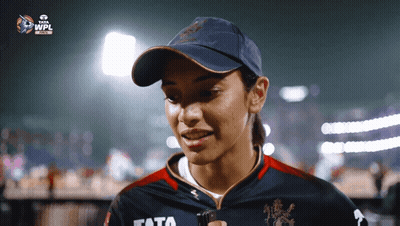 A Woman Wearing A Hat And A Shirt With The Word Tata On It GIF