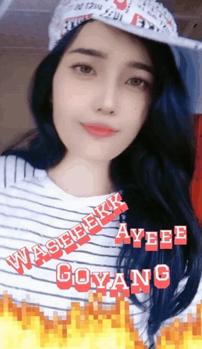 A Woman Wearing A Hat And A Striped Shirt With Ayee Goyang In Red Letters GIF