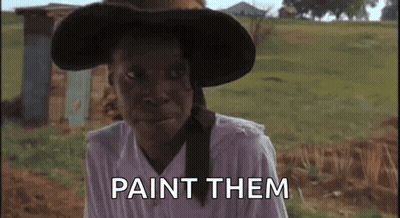 A Woman Wearing A Hat And A White Shirt Says Paint Them GIF