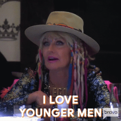 A Woman Wearing A Hat And Dreadlocks Says I Love Younger Men GIF