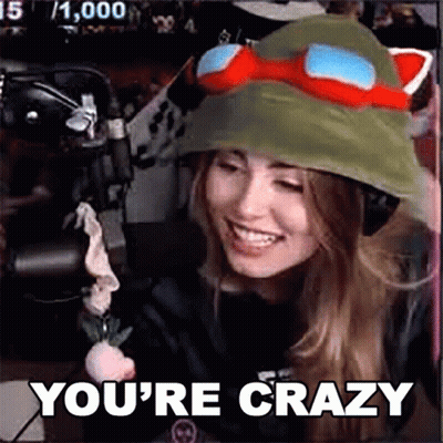 A Woman Wearing A Hat And Goggles Is Sitting In Front Of A Microphone And Says `` You 'Re Crazy '' . GIF