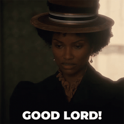 A Woman Wearing A Hat Says Good Lord On The Bottom GIF