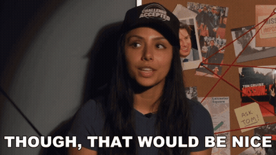 A Woman Wearing A Hat That Says Challenge Accepted Stands In Front Of A Bulletin Board GIF