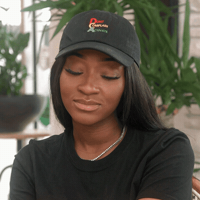 A Woman Wearing A Hat That Says " Do N't Complain " GIF