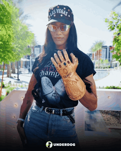 A Woman Wearing A Hat That Says Las Vegas Holds Up A Glove GIF