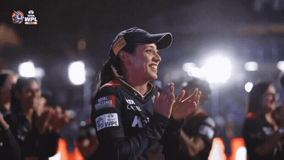 A Woman Wearing A Hat That Says Royal Challenge GIF