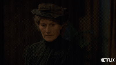 A Woman Wearing A Hat With A Netflix Logo On The Bottom GIF