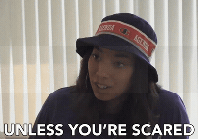 A Woman Wearing A Hat With Agenda On It GIF