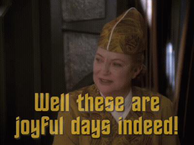 A Woman Wearing A Hat With The Words Well These Are Joyful Days Indeed GIF