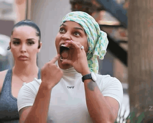 A Woman Wearing A Head Scarf And A White Shirt That Says Off GIF