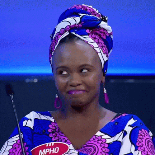 A Woman Wearing A Head Scarf And Earrings Has A Name Tag That Says Mpho GIF