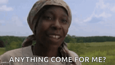 A Woman Wearing A Head Scarf Is Smiling In A Field And Asking Anything Come For Me . GIF